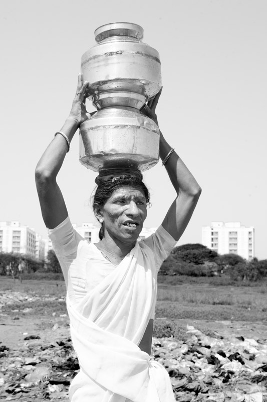 Water portraits - An eunuch taking water for herself and her associates from a public standpoint away from her home – Mumbai city, Maharashtra